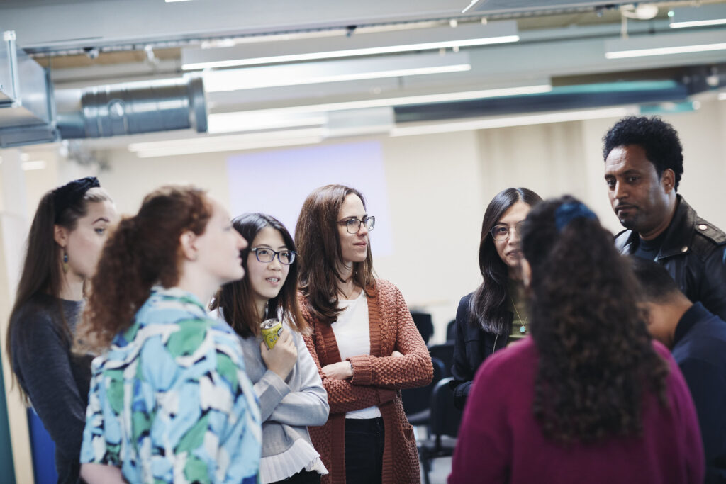 Renaisi staff talking in a group.